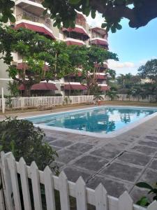 a swimming pool in front of a building at Rooms By the Pool in Kingston