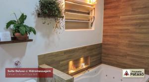 a bathroom with a bath tub with a fireplace at Pousada Pataxó in Ubatuba +42 photos