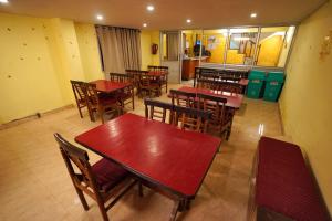 an empty restaurant with wooden tables and chairs at Hotel Atithi Mall Road in Shimla