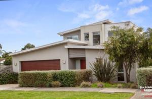 a large white house with a garage at Redwood Delight in Cowes