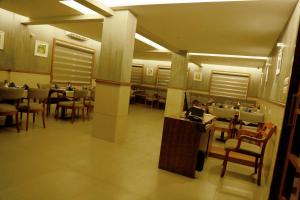 a dining room with tables and chairs in a restaurant at Hill Heights in Cochin