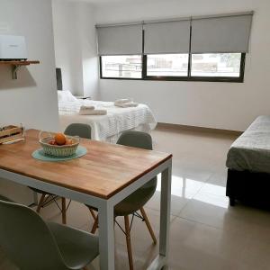 a room with a table with a bowl of fruit on it at Patagonia Apart in Paraná