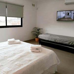 a bedroom with two white towels on a bed at Patagonia Apart in Paraná