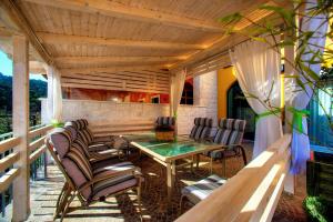 a patio with chairs and a table on a deck at Villa Barbara in Skradin