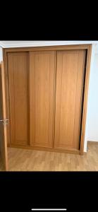 a pair of wooden cabinets in a room at APARTAMENTO EN PRIMERA LINEA DE PLAYA RiAZOR in A Coruña