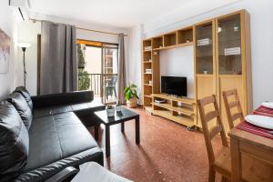 a living room with a couch and a table at MONKÓ CACTUS in Torremolinos