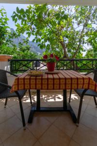 a table with a flower pot on top of it at Villa Sophia Apartments by CorfuEscapes in Agios Gordios +62 photos
