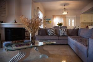 a living room with a couch and a table at Villa Mary in Kefallonia