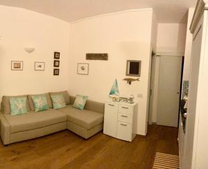 a living room with a couch and a table at Dammuso Bacio Pantesco in Pantelleria