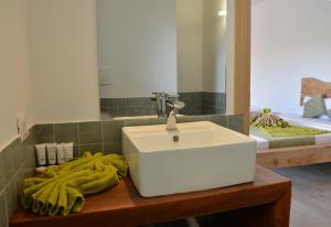 a bathroom with a white sink and a mirror at La Base Beach Hotel in Kiwengwa +46 photos