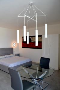a bedroom with a bed and a glass table at aura AR holiday-home in Peschiera del Garda
