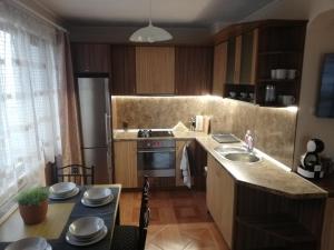 a kitchen with a sink and a stove top oven at Приключение в Триград in Trigrad