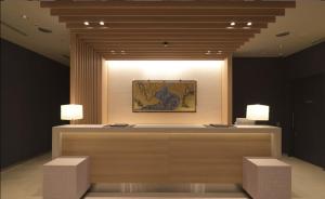 a room with two lights and a table with two stools at First Cabin Kansai Airport in Izumi-Sano