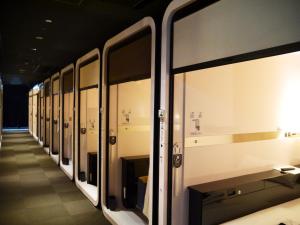 a subway train with its doors open in a station at First Cabin Kansai Airport in Izumi-Sano