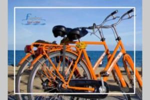 an orange bike is parked on the beach at Paxos StoneHouse in Gaios