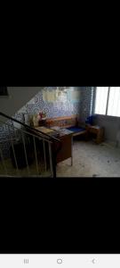 a living room with a table and a couch at Guest House Pacifica in Quarteira