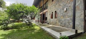 a stone building with a bench in front of it at Oasis Bungalow - Nuwara Eliya in Nuwara Eliya