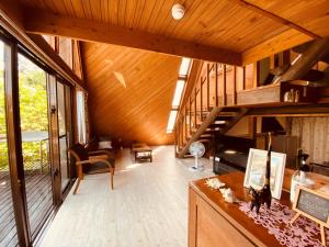 a living room with a staircase in a house at Sea Breeze in Onna