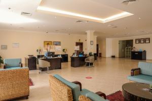 an office lobby with chairs and desks and tables at Dhafra Beach Hotel in Jebel Dhanna +37 photos