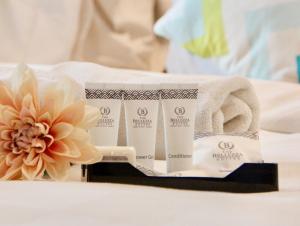 A bed or beds in a room at The Bellezza Hotel Suites