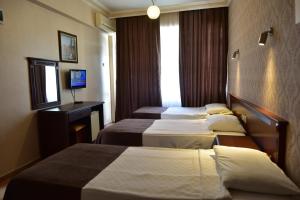 Postel nebo postele na pokoji v ubytování Temiz Hotel