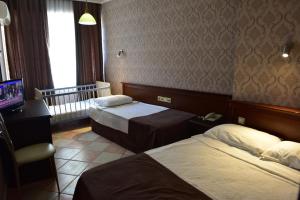 Postel nebo postele na pokoji v ubytování Temiz Hotel