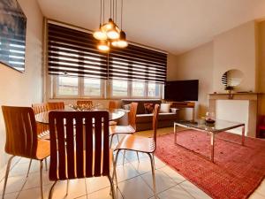 a living room with a table and a dining room at Fenêtre sur le Standard de Liège in Ougrée