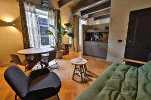 a living room with a couch and a table at Hotel de ABDIJ Dokkum in Dokkum