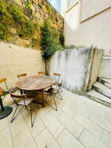 a table and chairs on a patio with a waterfall at San Lazaro in Ajaccio
