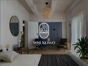 a bedroom with a bed and a sign that reads winatown at Siedlisko Wnukowo in Szczechy Małe