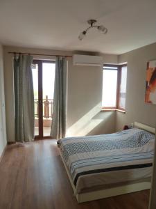 a bedroom with a bed and a large window at Summer Breeze Villa in Balchik +31 photos
