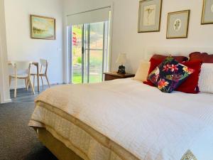 a bedroom with a bed and a table and chairs at Mountain Valley in Batehaven