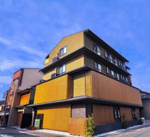 a yellow and black building on a street at HIZ HOTEL Kyoto Nijo Castle - Vacation STAY 12567v in Kyoto +4 photos