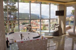 a large bathroom with a tub and a large window at Safi in Dospat