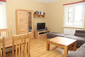 a living room with a couch and a television at Apartment Prenzlauer Berg in Berlin