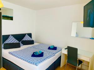a bedroom with a bed with blue towels on it at Big and Beautiful in Hannover