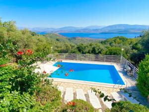 a swimming pool with a view of the water at Villa Marialetta St Stephanos with private pool by DadoVillas in Agnítsini