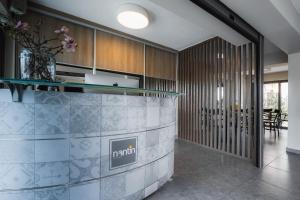 a kitchen with wooden cabinets and a vase of flowers at Nantin in Ioannina +27 photos