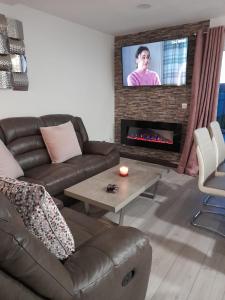 a living room with a couch and a fireplace at Doonan Breeze in Donegal