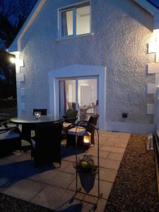 a patio with a table and chairs in front of a building at Doonan Breeze in Donegal