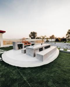 a group of concrete tables on a grass field at Seven Elements Resort in Ras al Khaimah