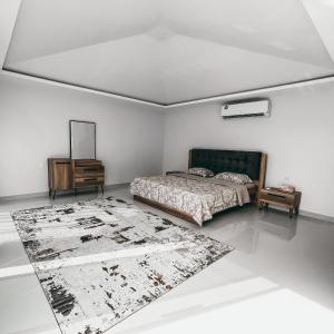 a bedroom with a bed and a rug on the floor at Seven Elements Resort in Ras al Khaimah