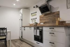 a kitchen with white cabinets and a counter top at Haus Emmerich in Gaienhofen