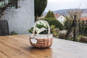 a basket of flowers sitting on a table at Haus Emmerich in Gaienhofen