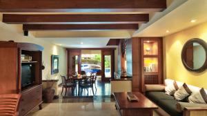 a living room with a couch and a table at Pool Villa Merumatta Senggigi in Senggigi