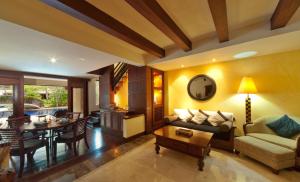 a living room with a couch and a table at Pool Villa Merumatta Senggigi in Senggigi