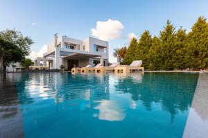 a house with a swimming pool in front of it at Artemisia Residence in Chania Town
