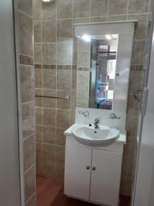 a bathroom with a sink and a shower with a mirror at Margate, Granada 102 in Margate