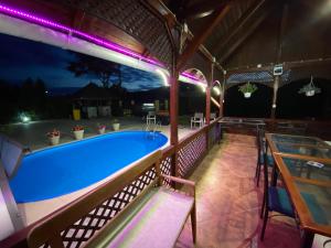 a pool on a deck at night with purple lights at Vila Eszter in Sovata