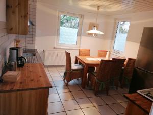 a kitchen with a table and chairs in a kitchen at Ellen`s Pension in Dobbrun